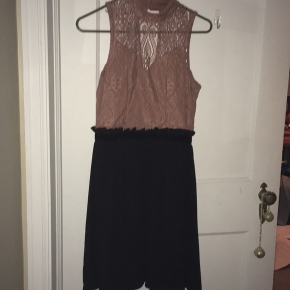 A dress with a black skirt and pick lace top. - Picture 1 of 3